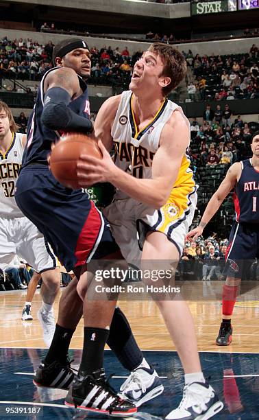 Tyler Hansbrough looks to score over Josh Smith of the Atlanta Hawks at Conseco Fieldhouse on December 26, 2009 in Indianapolis, Indiana. The Hawks...