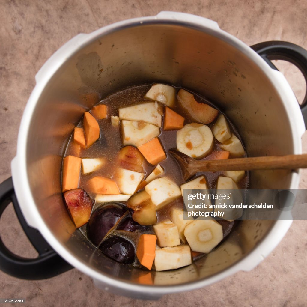 Pressure cooker pan with vegetables and beef gravy.