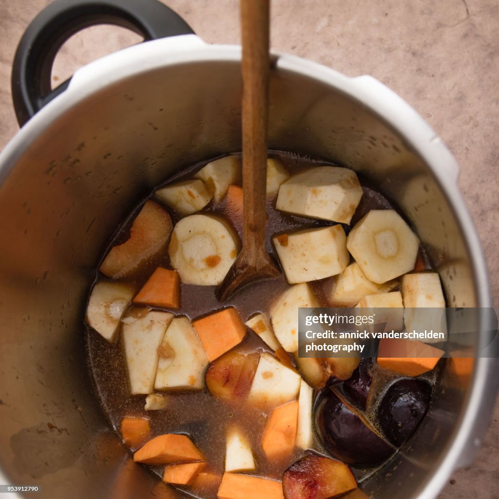 Pressure cooker pan with vegetables and beef gravy.