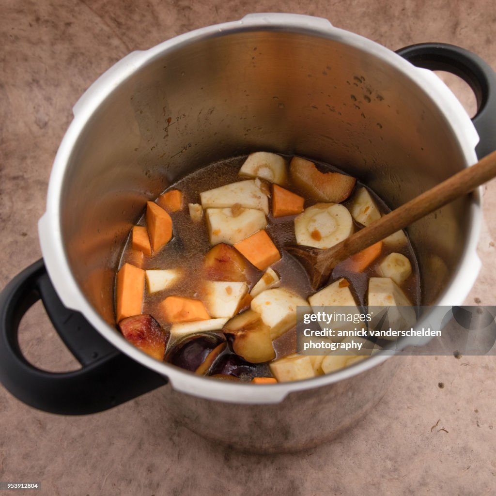 Pressure cooker pan with vegetables and beef gravy.