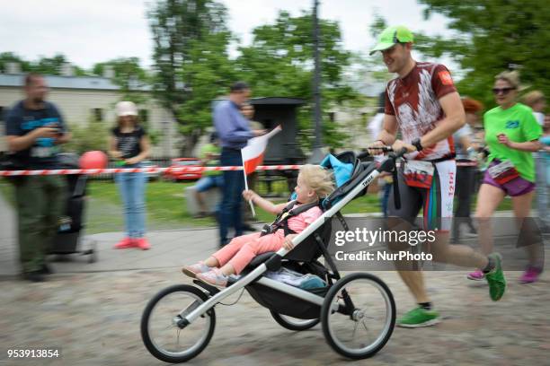 Participants are seen taking part in the Flag Day run in Warsaw, Poland on May 2, 2018. The Flag Day Run is a yearly five and ten kilometer run in...
