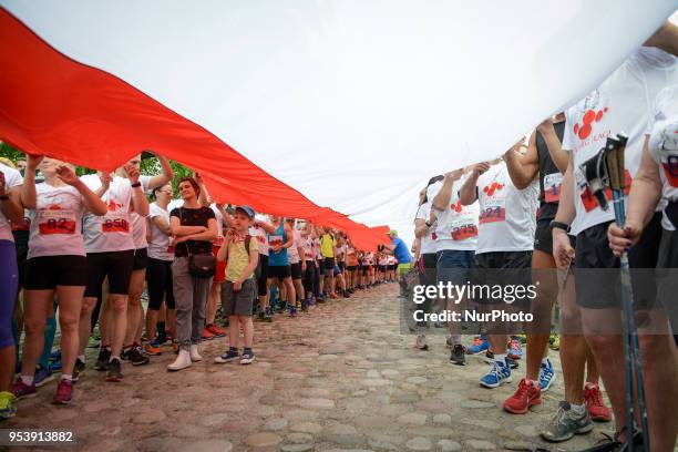 Giant Polish flag is seen being rolled out ahead of the start of the Flag Day run in Warsaw, Poland on May 2, 2018. The Flag Day Run is a yearly five...