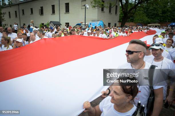 Giant Polish flag is seen being rolled out ahead of the start of the Flag Day run in Warsaw, Poland on May 2, 2018. The Flag Day Run is a yearly five...