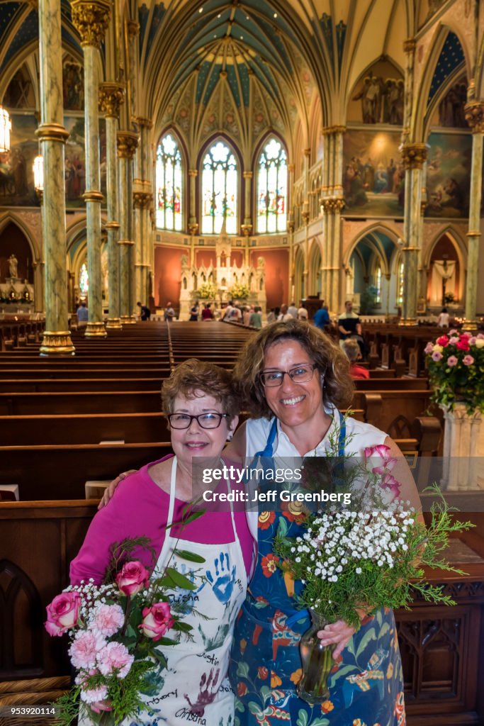Georgia, Savannah, Cathedral of St. John the Baptist, volunteers holding flowers
