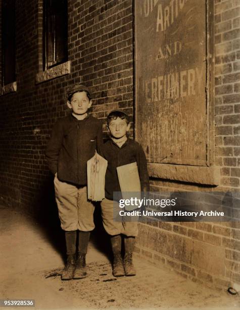 Isaac Solovitch, 12 years, David Solovitch, 7 years, Newsies, Portrait Standing at Night, Lawrence, Massachusetts, USA, Lewis Hine for National Child...