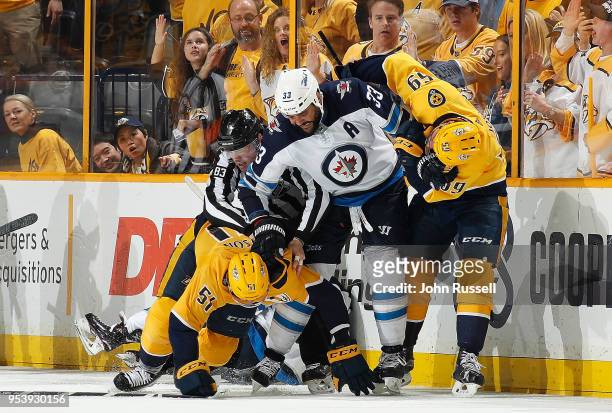 Dustin Byfuglien of the Winnipeg Jets gets physical with Austin Watson and Roman Josi of the Nashville Predators in Game Two of the Western...