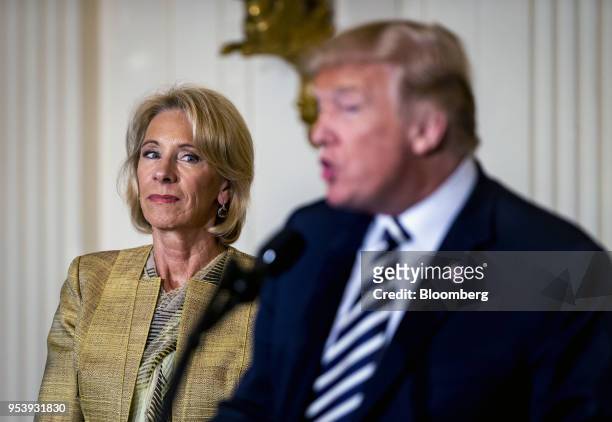 Betsy DeVos, U.S. Secretary of education, listens as U.S. President Donald Trump, right, speaks during the National Teacher of the Year reception in...