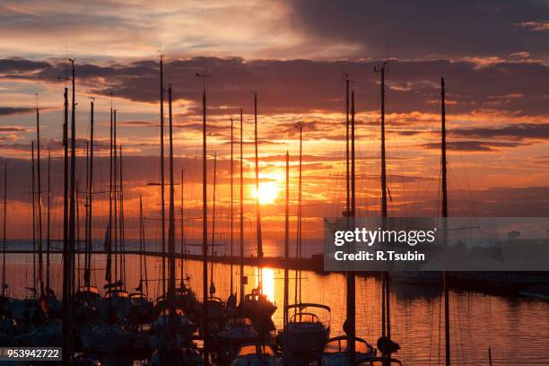 harbor and the yachts at dramatic sunset - view of boats moored at jetty in calm lake stock pictures, royalty-free photos & images