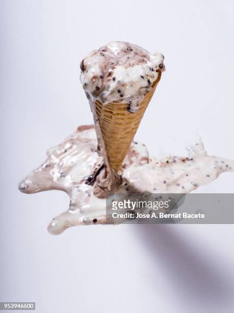chocolate ice cream in cone that has been spilt in the soil on a white bottom. - ice cream cone stockfoto's en -beelden
