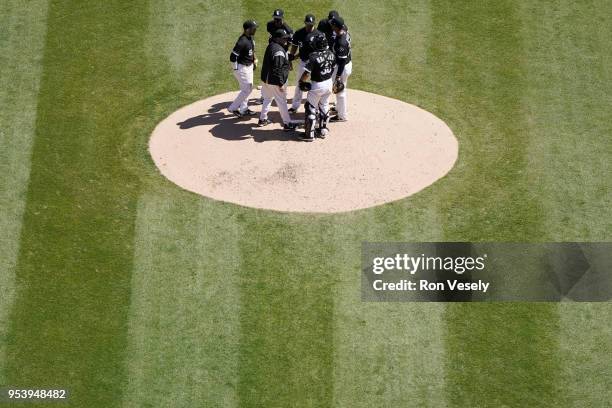 Pitching coach Don Cooper and the rest of the staring infield of the Chicago White Sox gather on the pitching mound to talk to James Shields during...