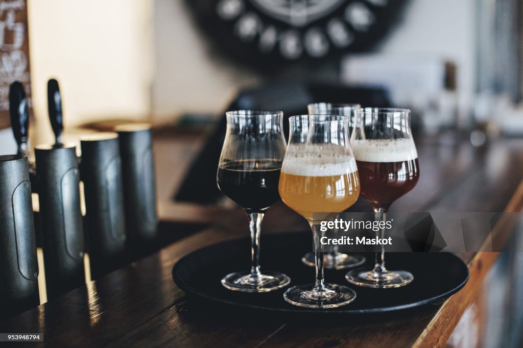 Close-up of various beer in glasses at bar counter
