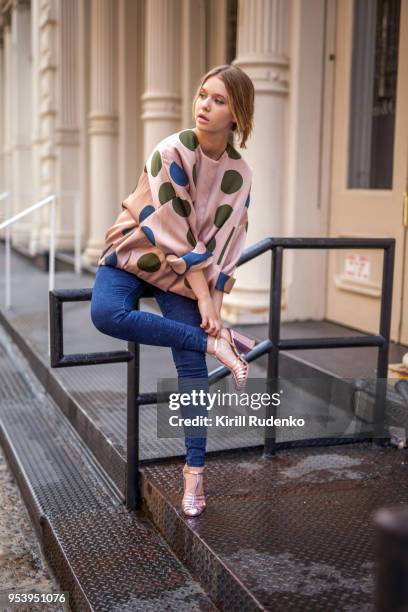 fashionable woman fixing her shoe on a street in soho, new york - high fashion model stock pictures, royalty-free photos & images