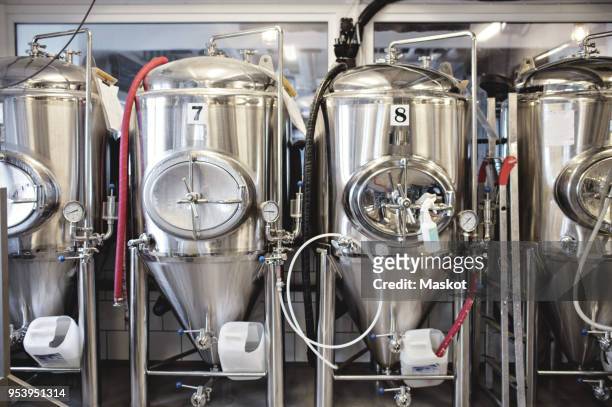 stainless steel storage tanks at brewery - bier brouwen stockfoto's en -beelden