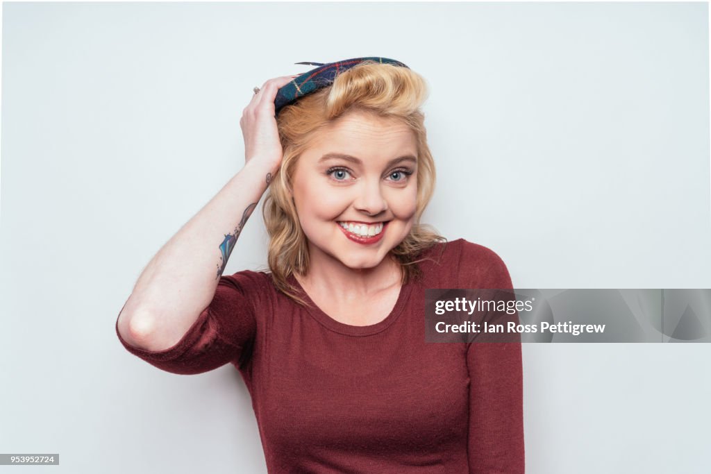 Beautiful blond woman with small plaid hat