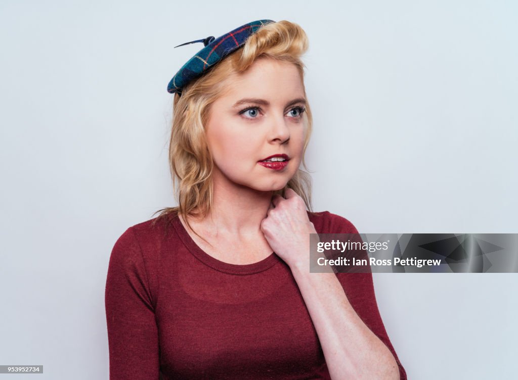 Beautiful blond woman with small plaid hat