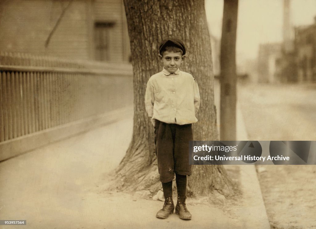 Dominic M. Giouchino, 8 years old, Newsie, Full-Length Portrait, Providence, Rhode Island, USA, Lewis Hine for National Child Labor Committee, November 1912