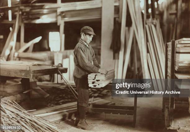 Boy Tying Up Wood Boards at Planing Mill, Evansville, Indiana, USA, Lewis Hine for National Child Labor Committee, October 1908.
