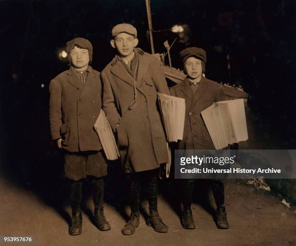 Three Young Boys Selling "Warheit" Jewish Newspapers at Midnight, Full-Length Portrait, Delancey Street, New York City, New York, USA, Lewis Hine for...