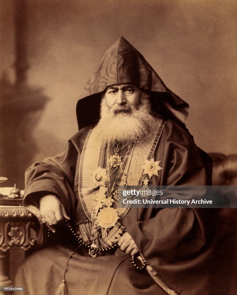 Armenian Patriarch of Jerusalem, Harootiun Vehabedian, Seated Portrait Wearing Hooded Vestment, Adorned with Crosses and other Medals, Holding a Strand of Beads, Jerusalem, American Colony Photo Department, early 1900's