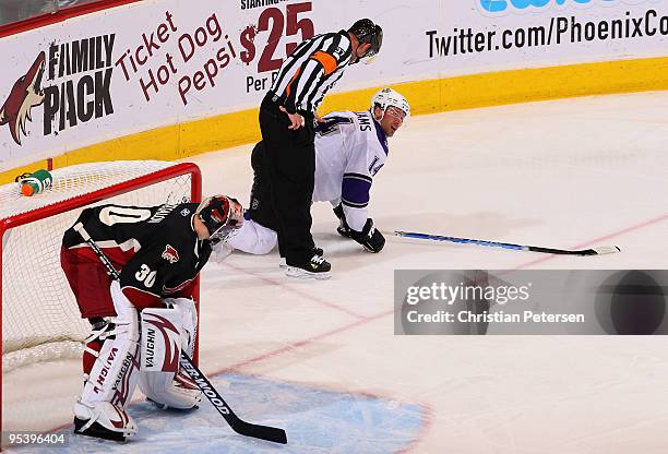 Justin Williams of the Los Angeles Kings reacts in front of goaltender Ilya Bryzgalov of Phoenix Coyotes after being injured in the first period of...