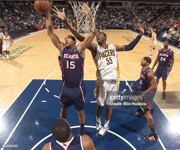 Al Horford of the Atlanta Hawks battles Roy Hibbert of the Indiana Pacers at Conseco Fieldhouse on December 26, 2009 in Indianapolis, Indiana. The...