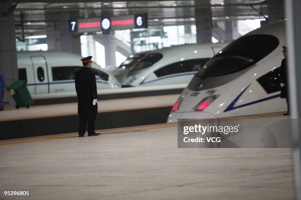 Trainman stands in front of a CRH train of Wuhan-Guangzhou High-Speed Railway at Changsha South Railway Station on December 26, 2009 in Changsha,...