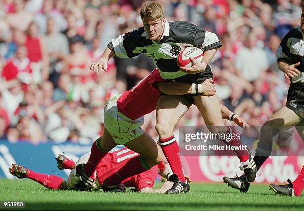 Tim Horan of Barbarians runs with the ball during the Scottish Amicable Tour match against Wales played at the Millennium Stadium, in Cardiff, Wales....