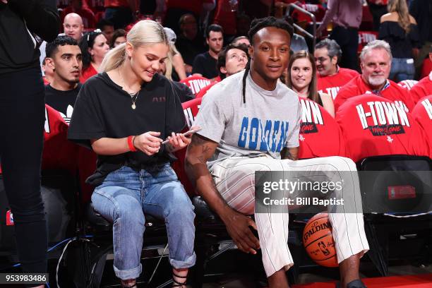 Deandre Hopkins and Amina Blue attend a game between the Houston Rockets and Utah Jazz in Game Two of Round Two of the 2018 NBA Playoffs on May 2,...