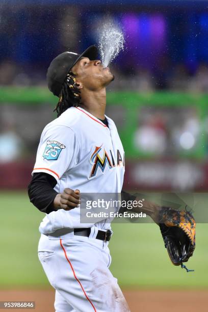 Jose Urena of the Miami Marlins spits water in the air before taking the mound in the first inning against the Philadelphia Phillies at Marlins Park...