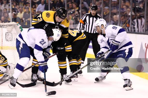 Charlie McAvoy of the Boston Bruins defends Brayden Point of the Tampa Bay Lightning during the second period of Game Three of the Eastern Conference...