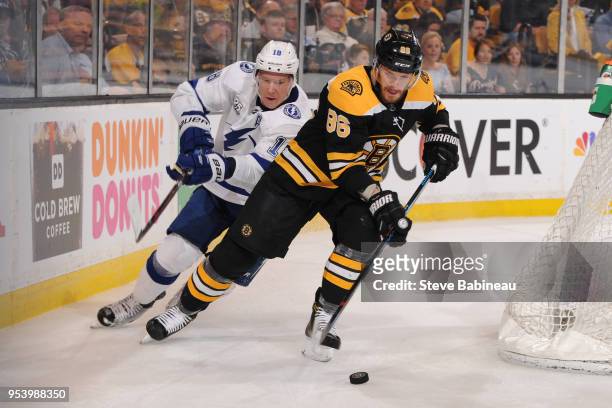 Kevan Miller of the Boston Bruins skates with the puck against Ondrej Palat of the Tampa Bay Lightning in Game Three of the Eastern Conference Second...