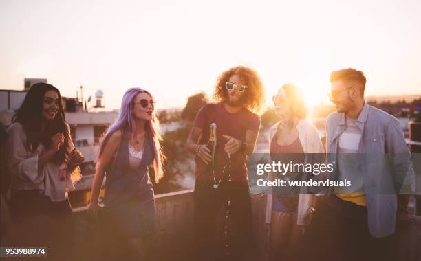 group of hipster friends celebrating with champagne at summer party - champagne rooftop stock pictures, royalty-free photos & images