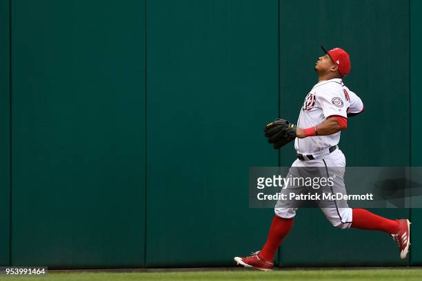 Moises Sierra of the Washington Nationals watches a fan in the stands catch David Peralta of the Arizona Diamondbacks solo home run in the fourth...