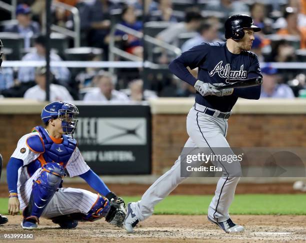 Freddie Freeman of the Atlanta Braves hits a single in the eighth inning as Jose Lobaton of the New York Mets defends on May 2, 2018 at Citi Field in...