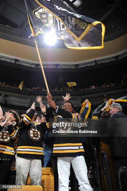 Fan banner captain, former Red Sox pitcher, Pedro Martinez, waves the flag before the game of the Boston Bruins against the Tampa Bay Lightning in...