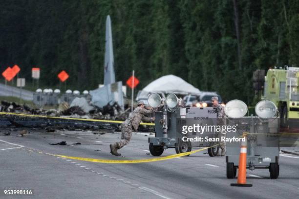 Emergency responders move equipment across Route 21 where an Air National Guard C-130 cargo plane crashed May 2, 2018 in Port Wentworth, Georgia. The...
