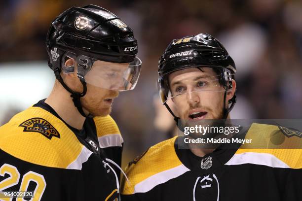 Riley Nash of the Boston Bruins talks with Matt Grzelcyk during the second period of Game Three of the Eastern Conference Second Round during the...