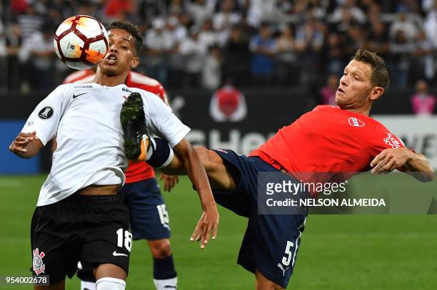 Pedrinho of Brazil's Corinthians vies for the ball with Nicolas Domingo of Argentina's Independiente during their 2018 Copa Libertadores football...
