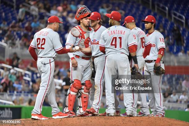 Manager Gabe Kapler of the Philadelphia Phillies takes the baseball from Aaron Nola during a pitching change in the eighth inning against the Miami...