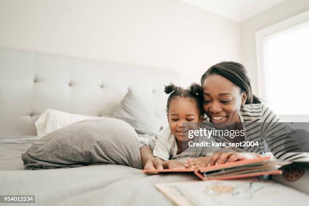 bedtime bonding - african american woman pajamas residential building stock pictures, royalty-free photos & images