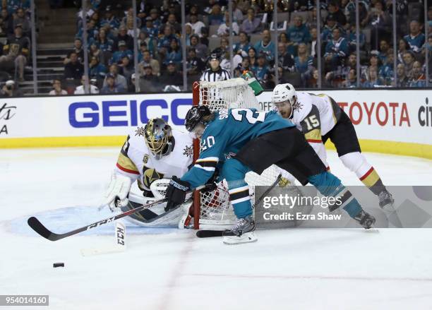 Marcus Sorensen of the San Jose Sharks is stopped from scoring by Jon Merrill and Marc-Andre Fleury of the Vegas Golden Knights during Game Four of...