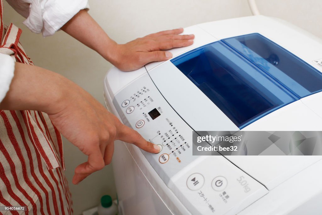 Asian woman and washing machine