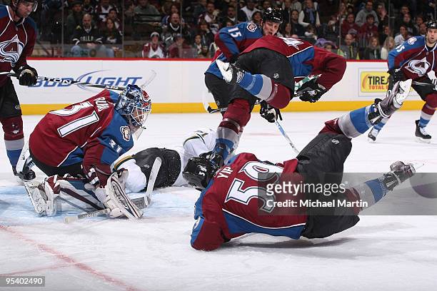 Goaltender Peter Budaj of the Colorado Avalanche looks on as teammates Ryan Wilson and Brandon Yip fall against the Dallas Stars at the Pepsi Center...