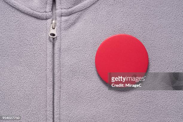 red button badge on gray cloth - brooch stock pictures, royalty-free photos & images