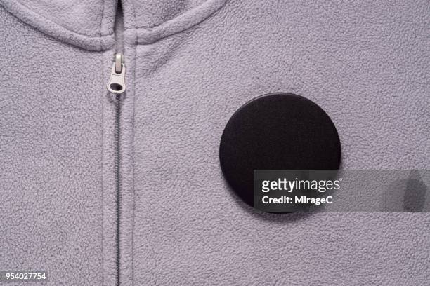 black button badge on gray cloth - brooch stock pictures, royalty-free photos & images