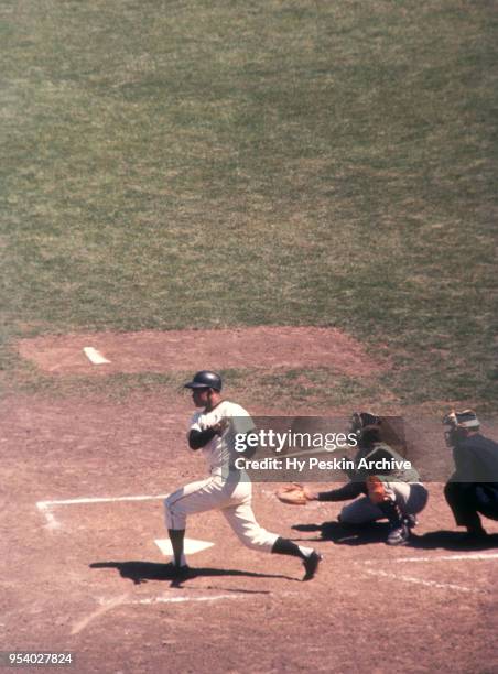 Felipe Alou of the San Francisco Giants swings at the pitch as catcher Orlando McFarlane of the Pittsburgh Pirates and umpire Paul Pryor look on...