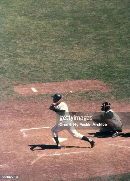 Felipe Alou of the San Francisco Giants swings at the pitch as catcher Orlando McFarlane of the Pittsburgh Pirates looks on during an MLB game on May...