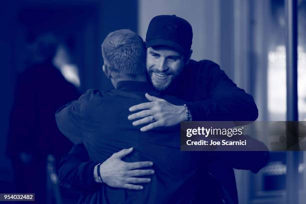 Liam Hemsworth greets Mick Fanning at the Teton Gravity Research's "Andy Iron's Kissed By God" World Premier at Regency Village Theatre on May 2,...