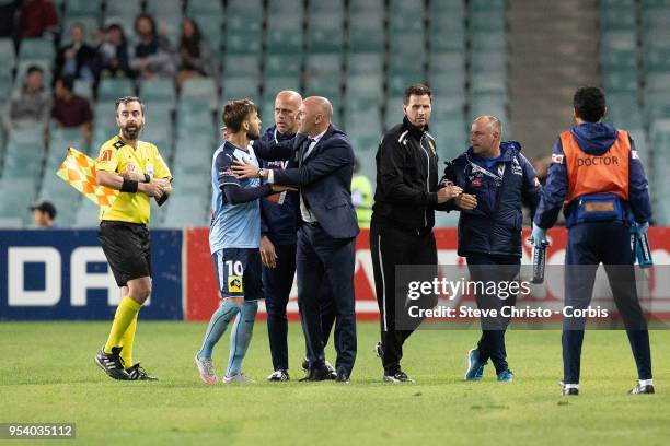 Milos Ninkovic of Sydney is restrained by Melbourne's coach Kevin Muscat when Victory's coaching staff ran on to the field of play after the winning...