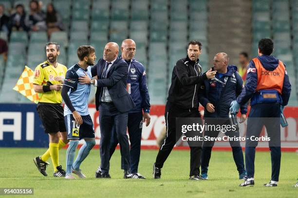 Milos Ninkovic of Sydney is restrained by Melbourne's coach Kevin Muscat when Victory's coaching staff ran on to the field of play after the winning...